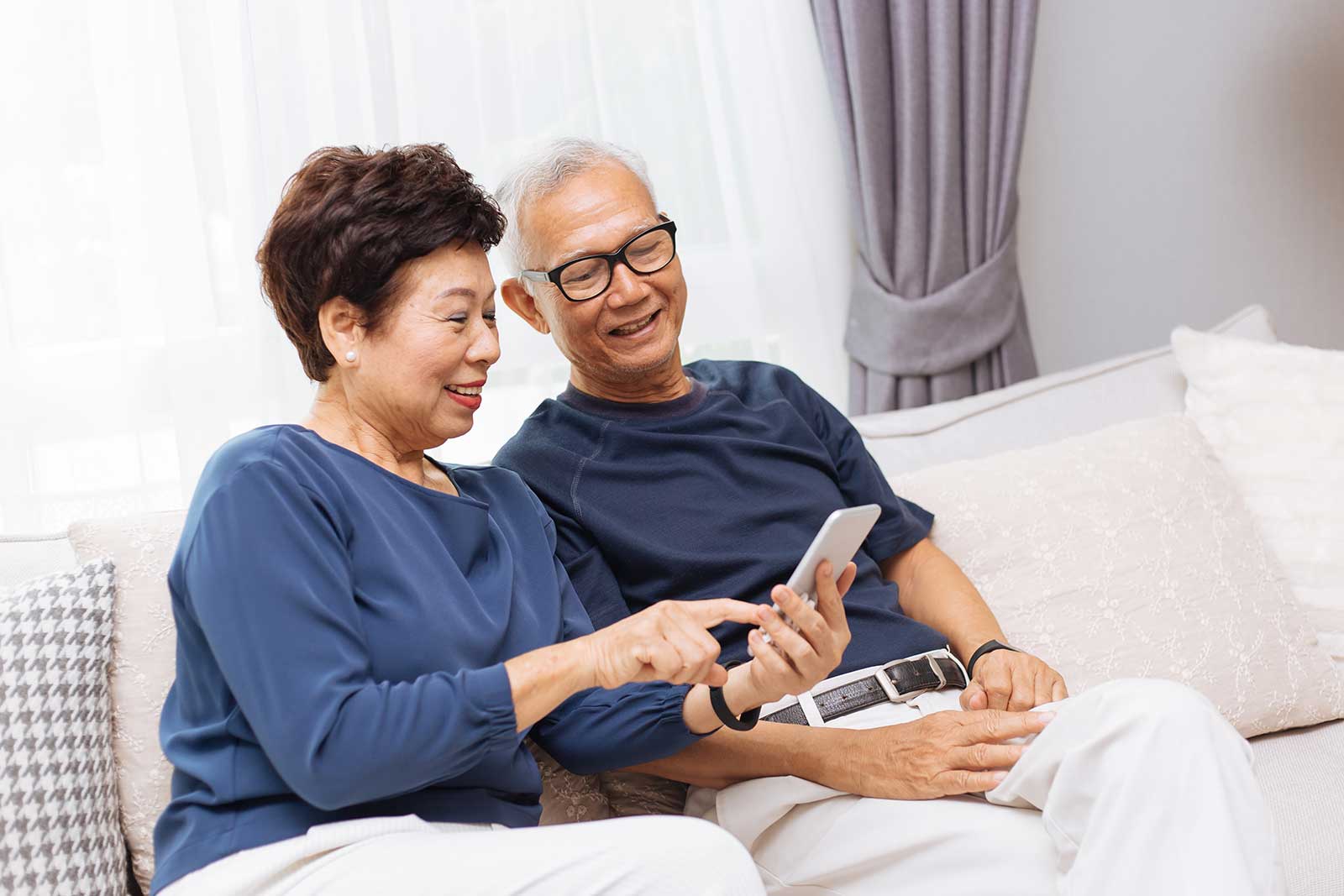 Asian couple reviewing their estate preservation life insurance policy