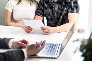 financial expert speaking with client about their life insurance coverage