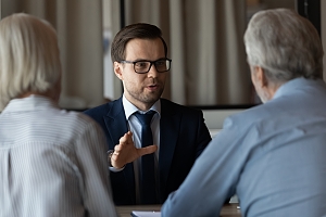 an adult daughter speaking with her father and insurance agent about estate policies