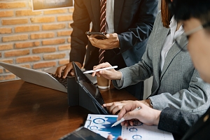 three business people reviewing the performance of insurance instruments as investments