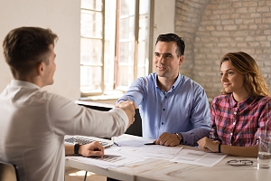 young tax consultant speaking with clients about portfolio