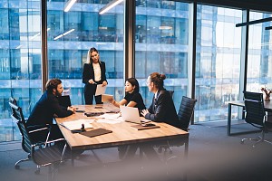 diverse group of colleagues discussing insurance plans together in a boardroom