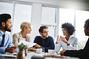 employees sitting together to discuss upcoming insurance changes