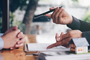 estate agent speaking with a client about contracts