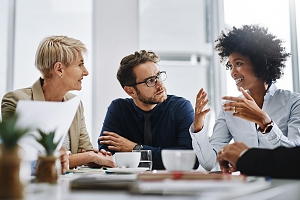 group of employees gathered around talking about their day