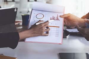 tax agents reviewing data on a chart