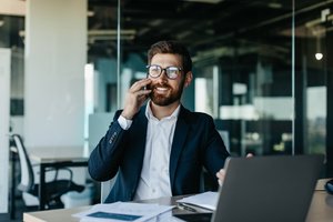 A man in professional attire working in the office