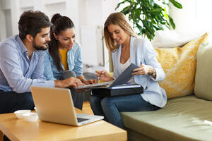 A female agent showing the plans of normal life insurance to a couple