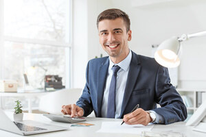 An insurance agent in his office reading over the benefits of a private placement life insurance policy