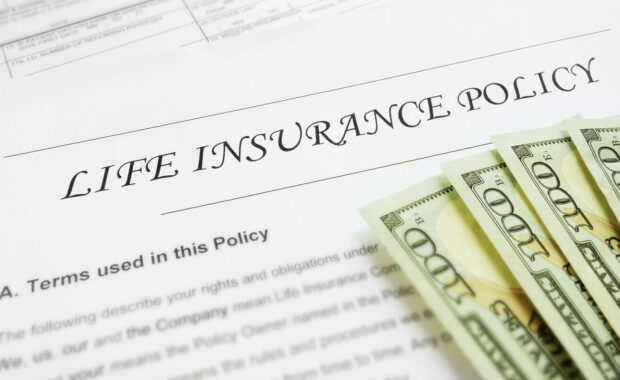 life insurance form with dollar bills