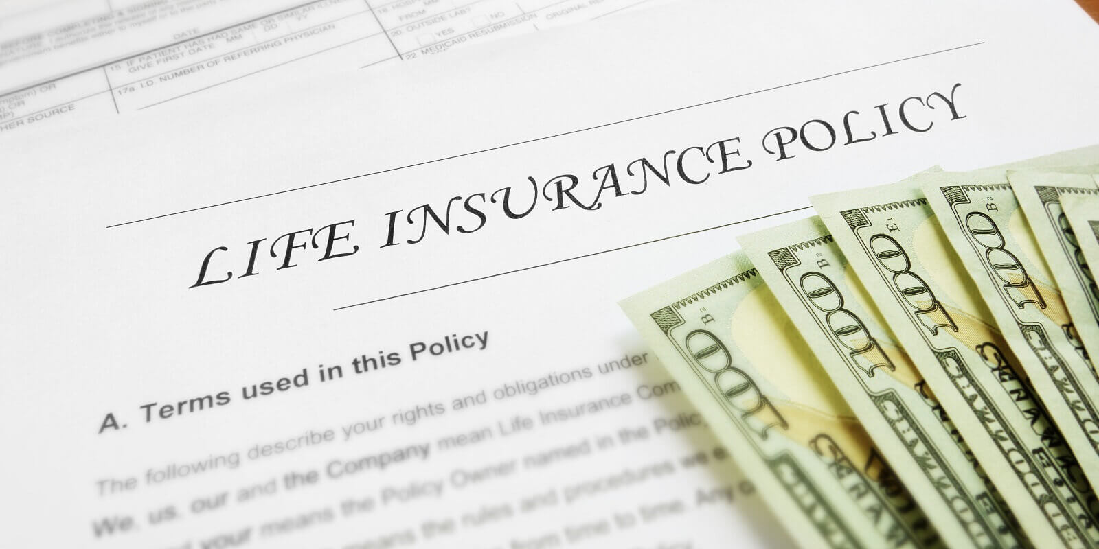 life insurance form with dollar bills